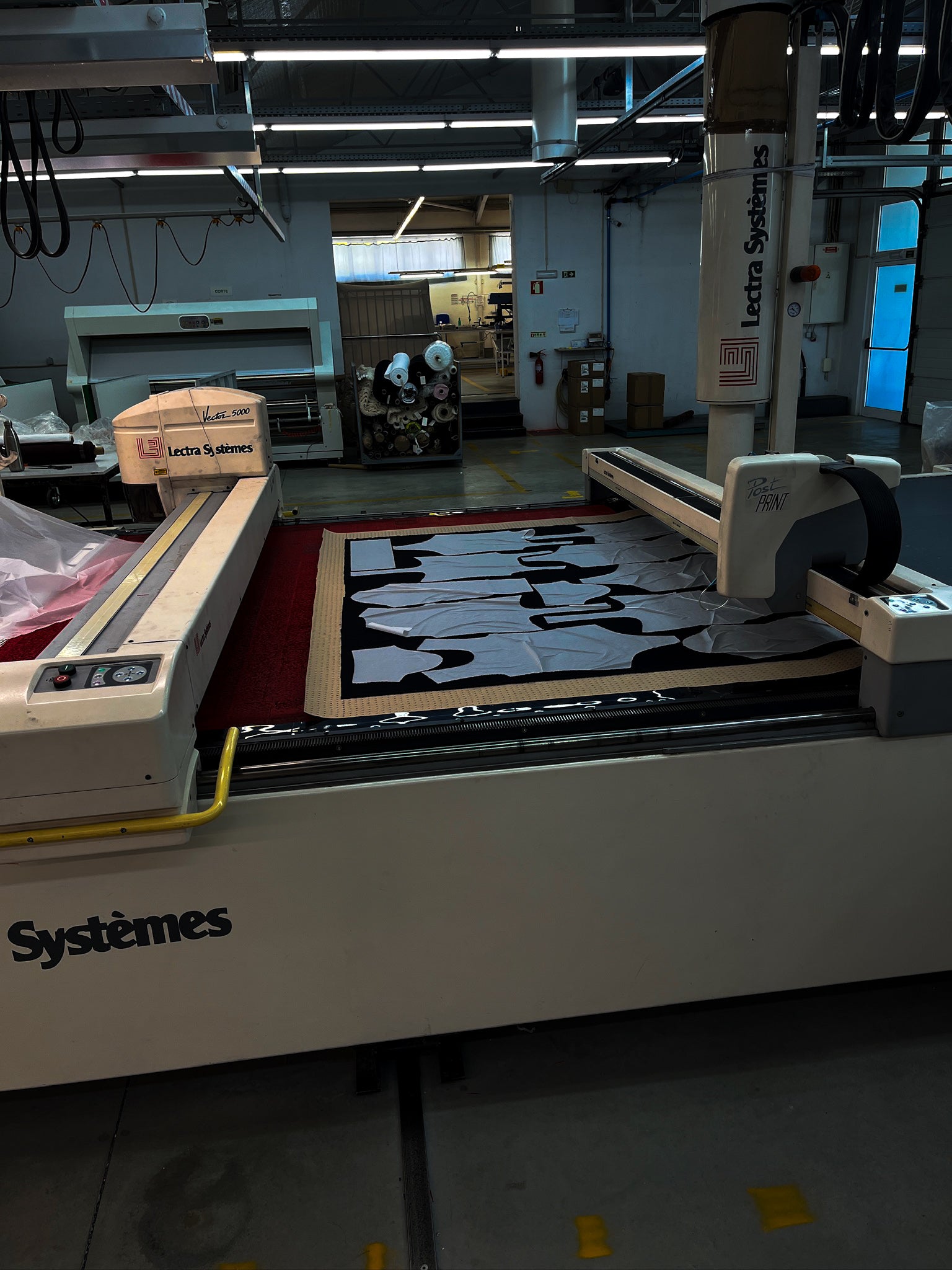 CNC fabric cutting machine is running in a potential Portuguese clothing  factory for Origin.