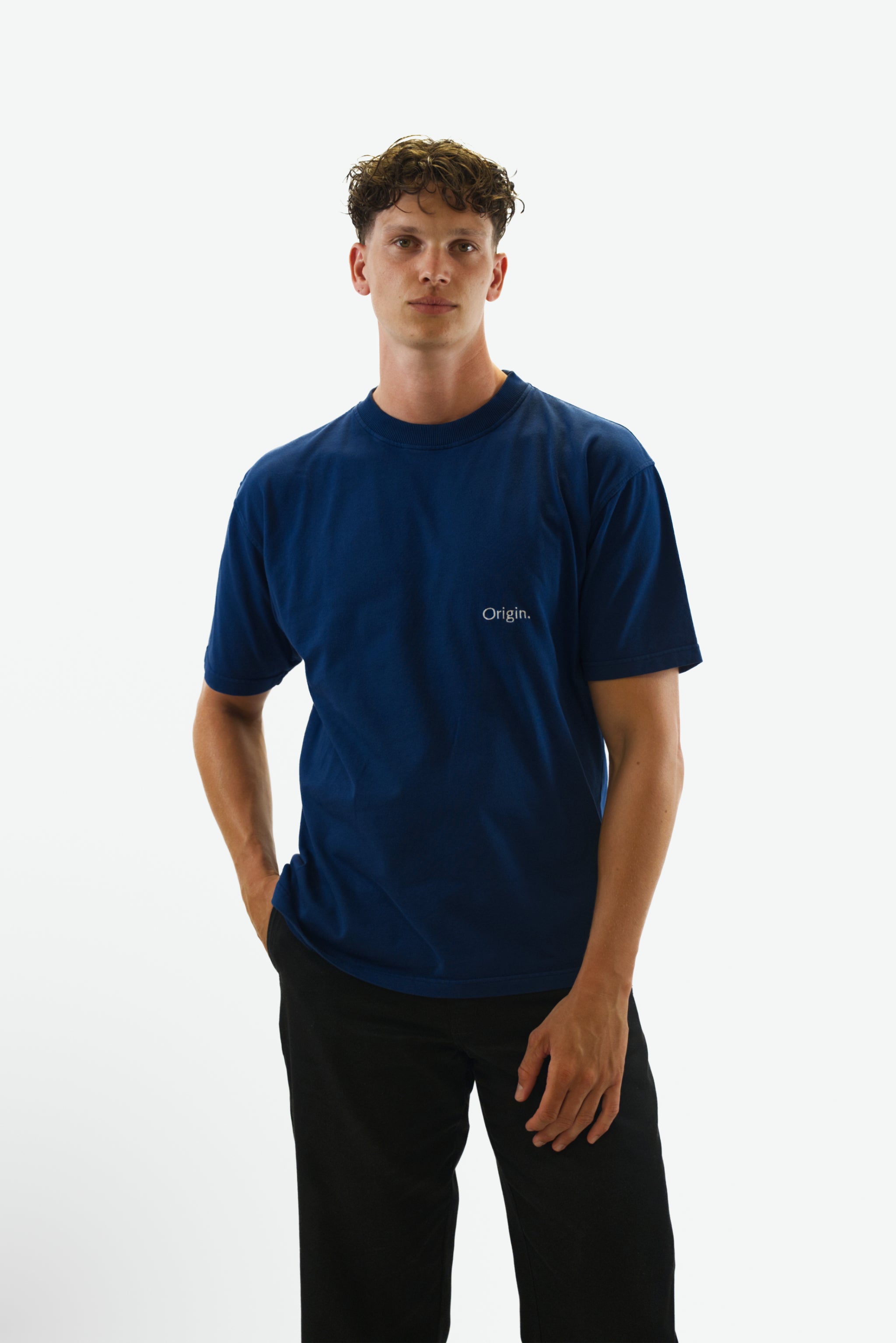 Front view of model wearing the Foundation Tee in indigo blue from Origin. made from organic cotton in a clean studio setting.