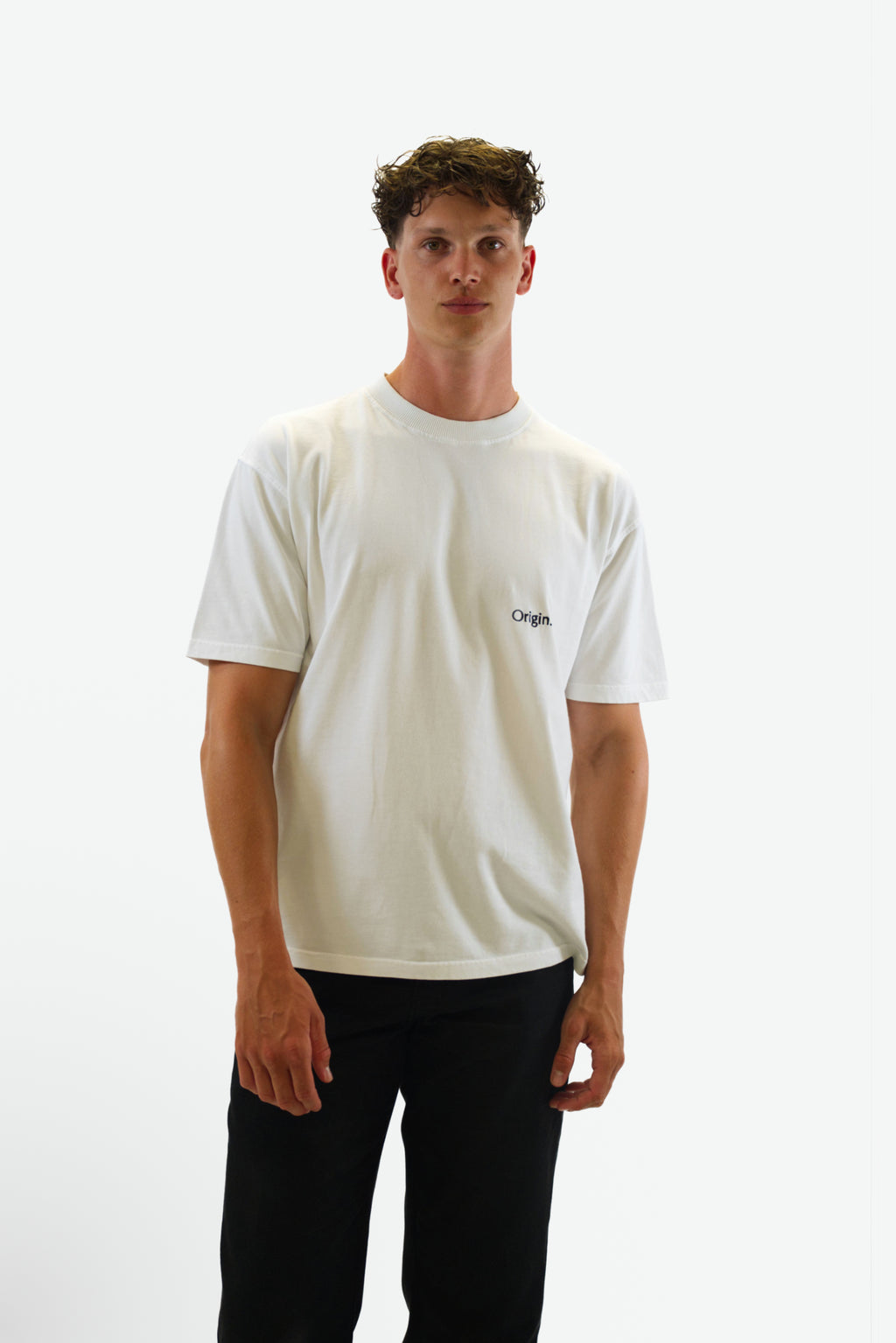 Front view of model wearing the Foundation Tee in white from Origin. made from organic cotton in a clean studio setting.