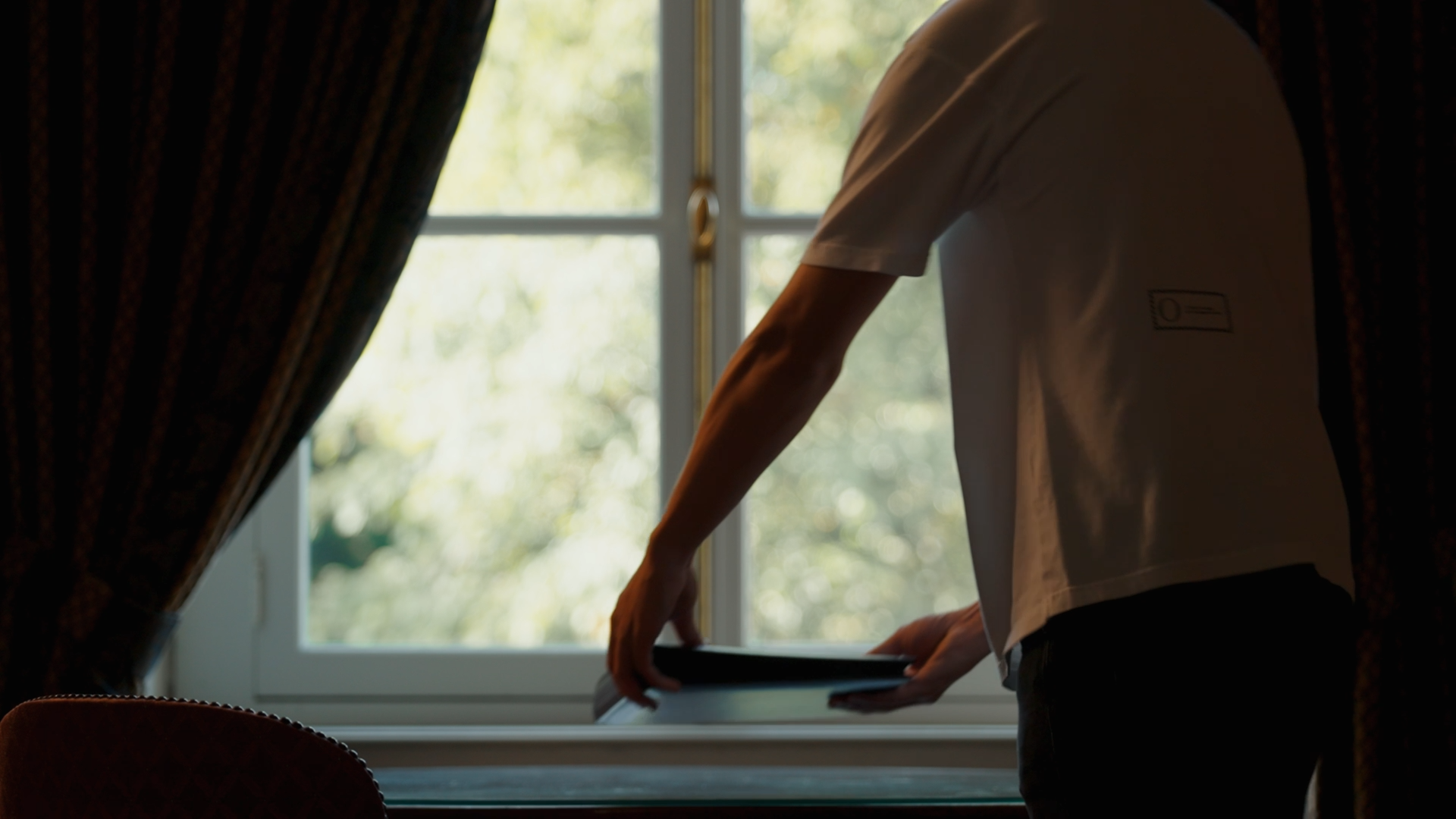 Founder Origin. wearing the Foundation Tee in white form Origin. and is acting for the writing scene “Chapter One.”.