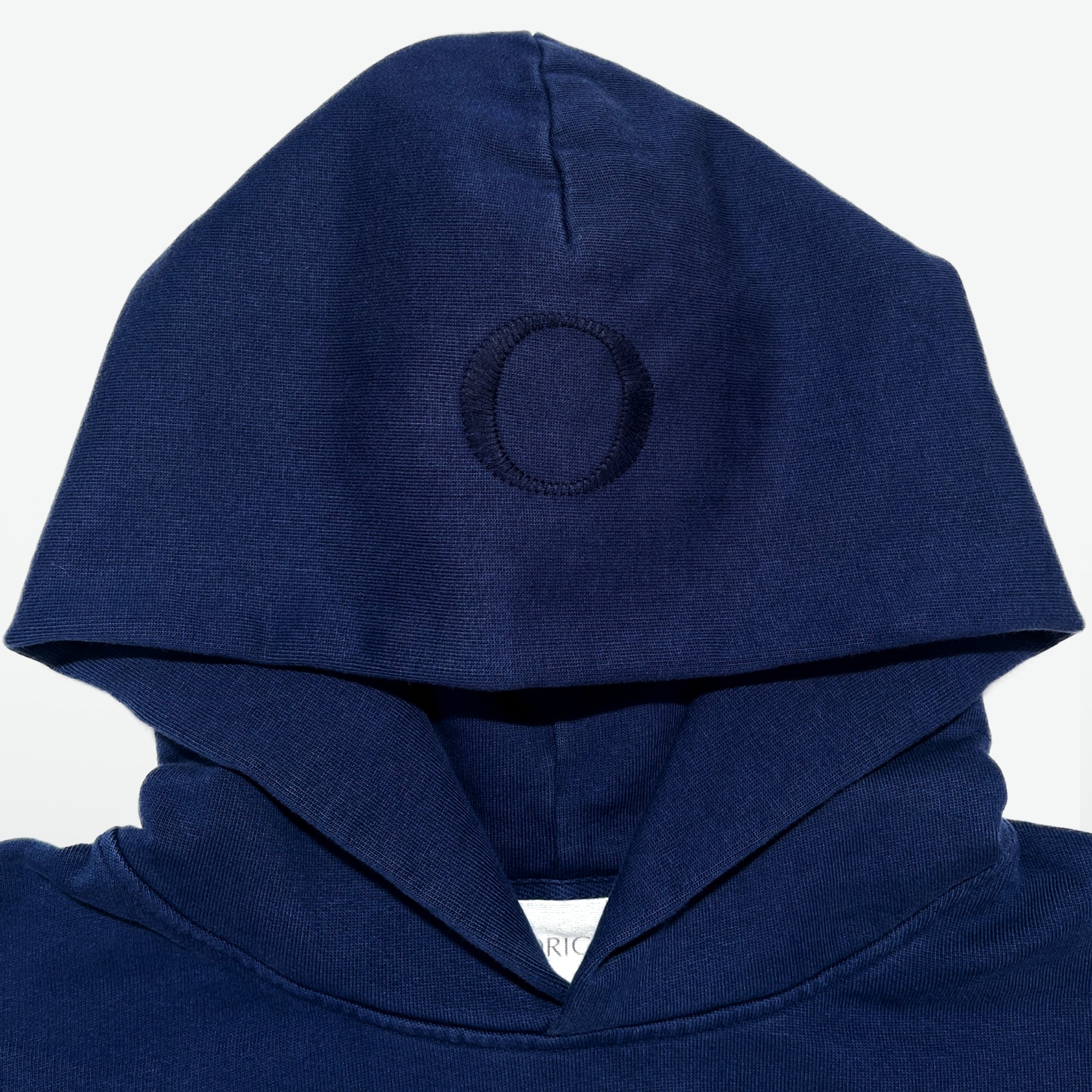 Neck/Hood detail Prelude Hoodie Origin. in Indigo Blue, featuring herringbone neck tape ribbed and organic cotton fabric with branded label.