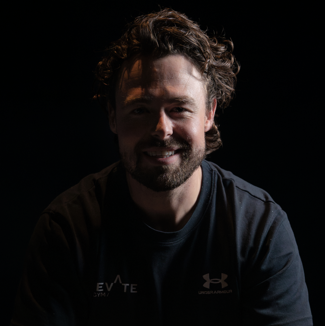Martijn portrait wearing a black shirt with a black background.
