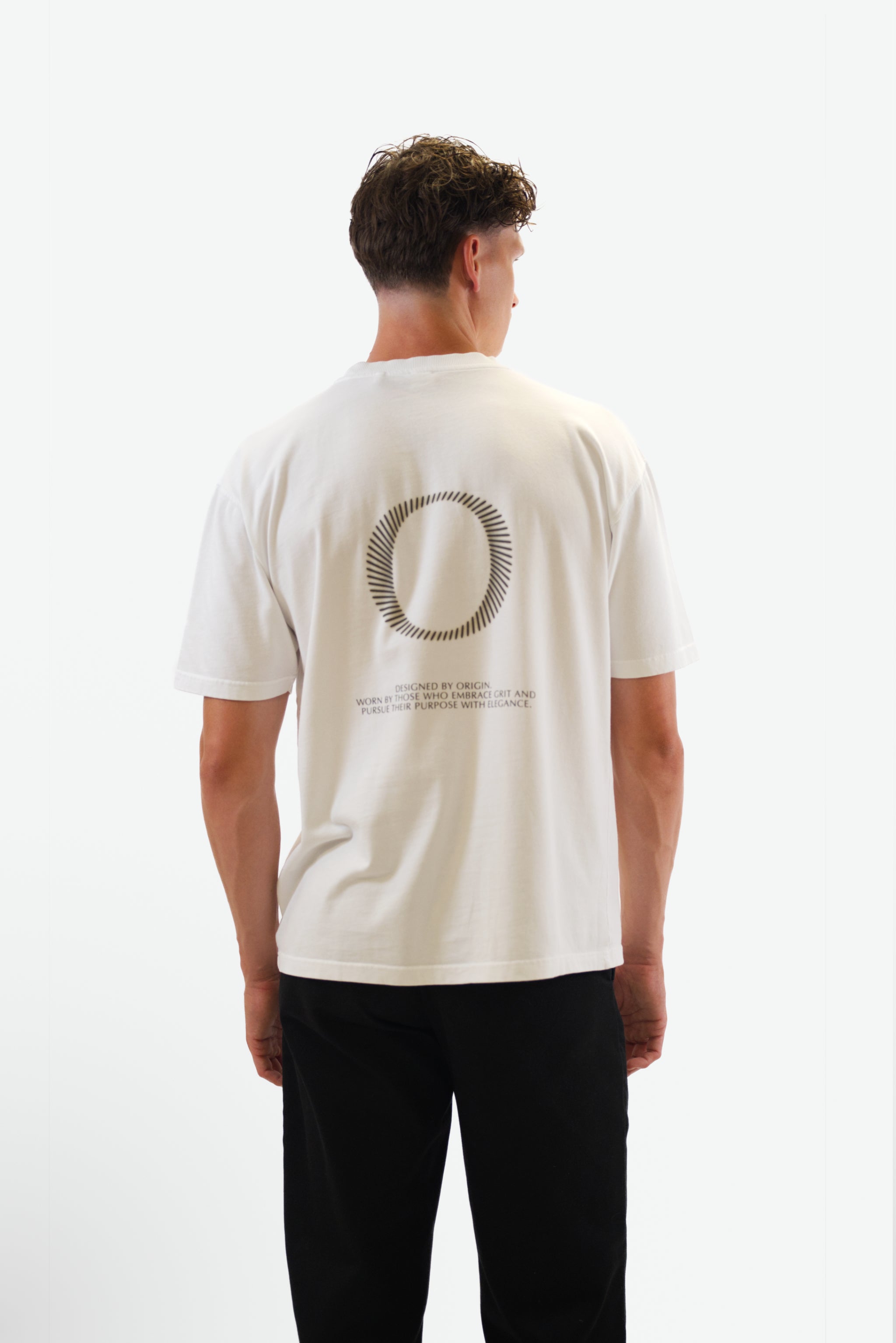 Back view of model wearing The Slash Tee in white from Origin. made from organic cotton in a clean studio setting.