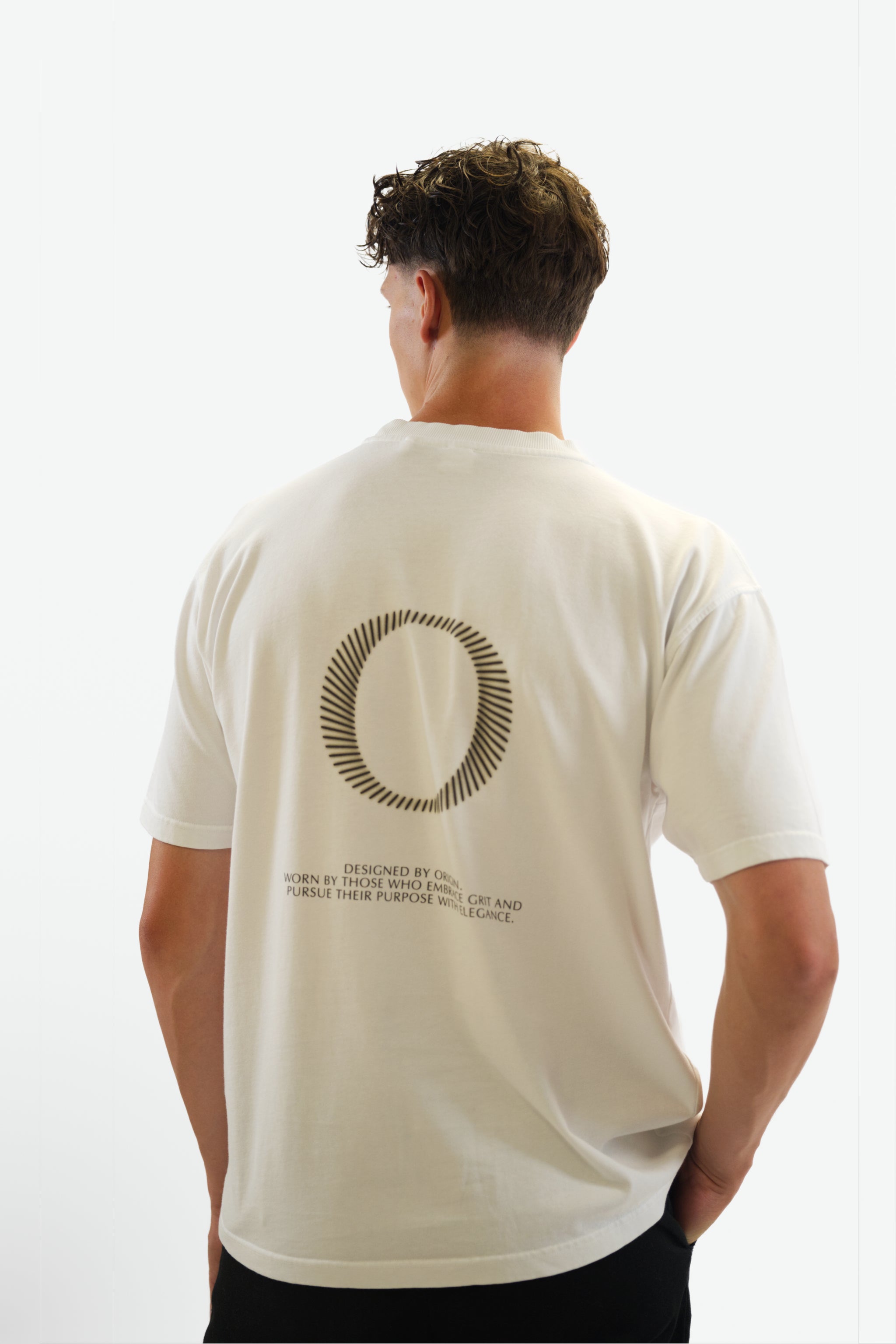 Back view close-up of model wearing The Slash Tee in white from Origin. made from organic cotton in a clean studio setting.