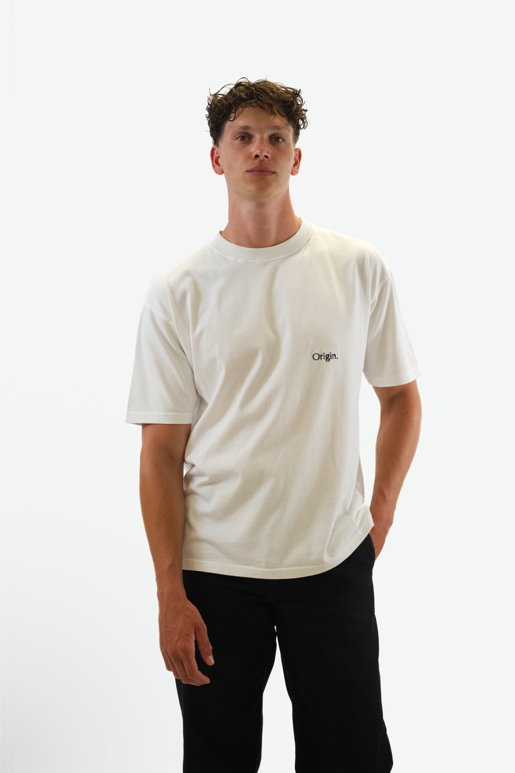 Front view of model wearing The Slash Tee in white from Origin. made from organic cotton in a clean studio setting.